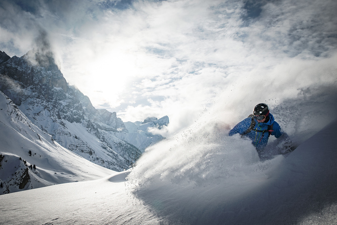 A skier does action skiing at the Rolle Pass in the Dolomites, Italy.